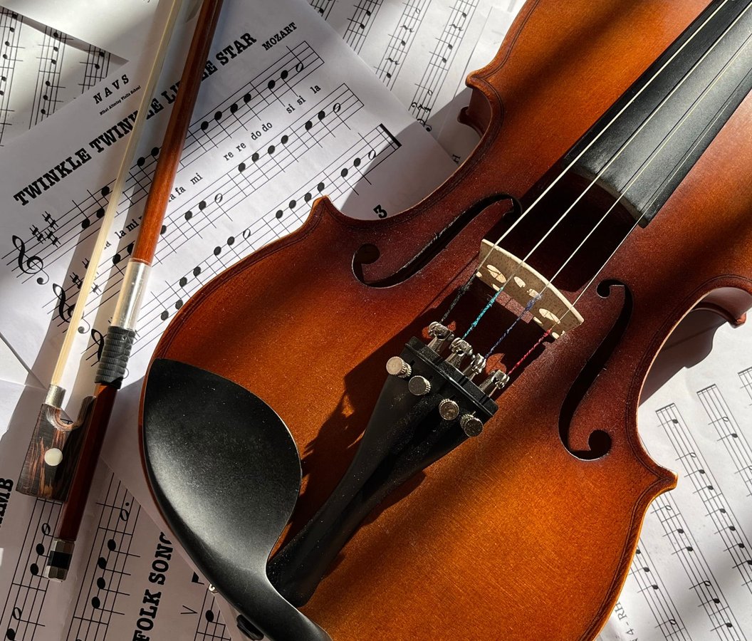 A violin and bow lying on sheet music